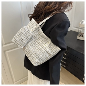 Detailed macro view of white and green tweed tote bag with leather trim and matching pouch
