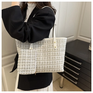 Detail of tweed tote and matching pouch with white leather trim and gold studs
