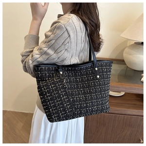 Close-up of black and gold tweed tote bag set with matching zippered small pouch