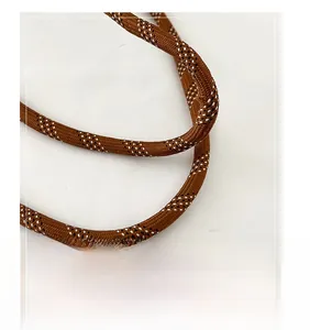 Detail view of brown woven rope strap with white starlight texture for casual tote bag