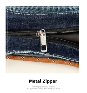 Close-up of polished silver metal zipper and woven cord on a dark blue denim tote bag