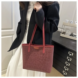 Close-up of red leopard print tote bag with gold Fashion logo and large capacity