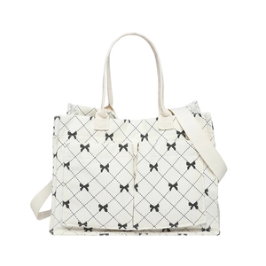 Large corduroy tote bag with black bow patterns and dual front pockets for shoulder use