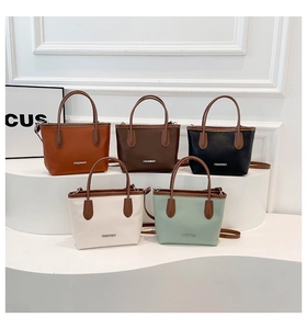 Detail view of colorful lychee grain leather bucket bags with adjustable shoulder straps