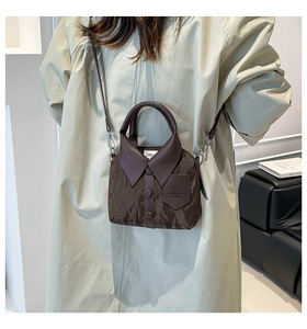 Detailed close-up of dark brown handbag featuring a creative shirt collar design and buttons