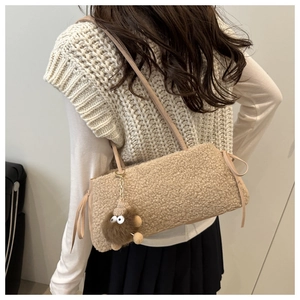 Detail of camel plush tote bag featuring fluffy texture and cute monster charm