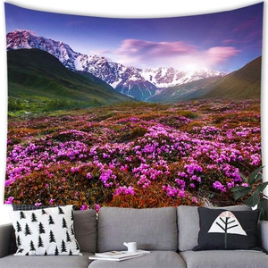 Scenic tapestry featuring snow mountains and purple flower fields hanging above a sofa