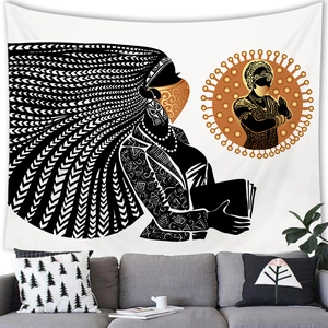 Detail of African woman wall tapestry hanging above a modern sofa in a cozy living room