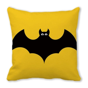 Detail of square yellow cushion cover featuring a cute black bat graphic for Halloween