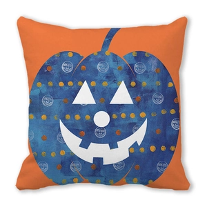 Close-up of Halloween peach skin pillowcase with blue pumpkin jack-o-lantern on orange base