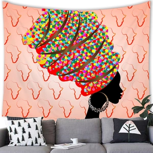 Detail of African woman wall tapestry hanging above a modern sofa for home decor