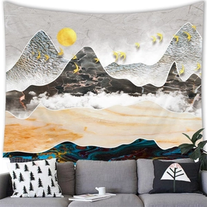 Abstract ink landscape tapestry with golden deer and sun over grey sofa decor