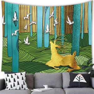 Artistic tapestry showing a golden deer and white birds over a gray sofa in a living room