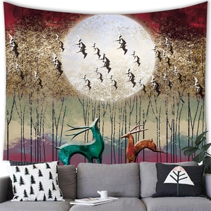 Detailed wall tapestry showing artistic forest with deer and moon over a sofa