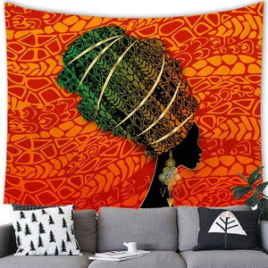 Detail of African woman wall tapestry on white wall above a modern grey sofa