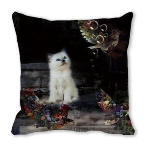 Macro detail of vintage collage print cushion cover with white cat and floral patterns