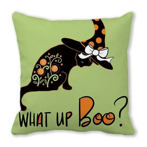 Detail of green Halloween cushion cover featuring black cat in witch hat with text