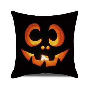 Halloween pumpkin cushion cover with glowing Jack-o'-lantern face on black fabric