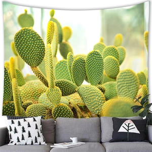 Watercolor cactus tapestry hanging above a sofa, vibrant sunset botanical wall decor fabric