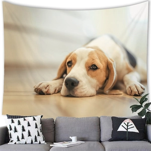 Close-up of a beagle dog wall tapestry hanging above a gray sofa in a warm living room decor