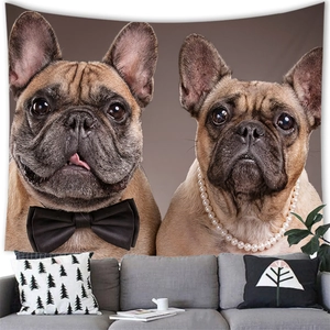 Detail of bulldog tapestry with bow and pearls hanging over a modern grey sofa