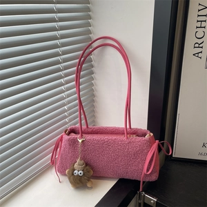 Pink plush faux fur tote bag with ribbon bows and cute monster charm accessory
