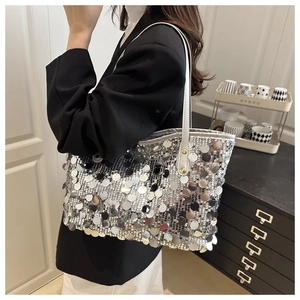 Close-up of large silver sequins and white strap on a stylish tote bag for party