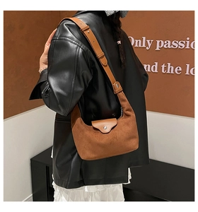 Close-up of retro brown frosted leather crescent bag with adjustable shoulder strap