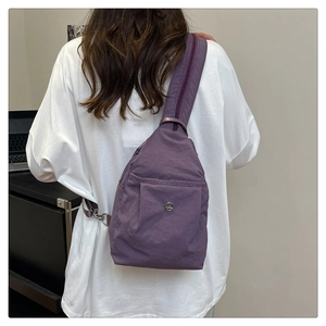 Detailed back view of model wearing a deep purple waterproof nylon crossbody chest bag