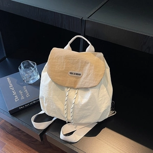 Minimalist beige and khaki nylon backpack with drawstring closure and campus style design
