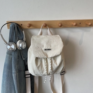 Fashionable off-white nylon backpack with adjustable straps and casual minimalist design