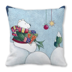 Macro detail of Christmas pillow showing polar bear illustration on peach skin fabric