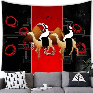Close-up of abstract African wall tapestry featuring pyramids and camels in red and black