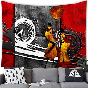 Detail of African abstract wall tapestry hanging above a grey sofa in a modern room