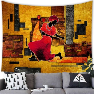 Abstract African woman wall tapestry hanging above a grey sofa in a modern room decor