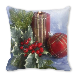 Detail of Christmas pillow cover with lit red candle berry and greenery on peach skin fabric