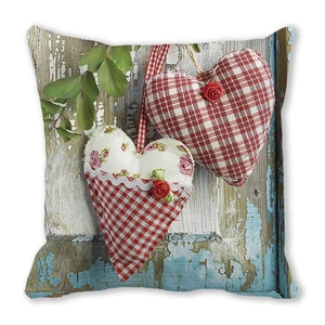 Detailed close-up of Christmas peach skin pillow featuring rustic heart print and foliage