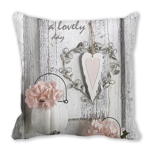 Detail of Christmas peach skin cushion cover with floral wreath and a lovely day print