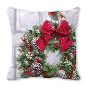 Detail of Christmas wreath throw pillow with red bow and robin on white background