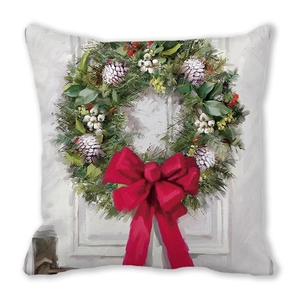 Macro detail of Christmas wreath cushion cover featuring festive red bow and berries