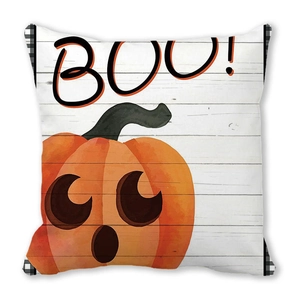 Close-up of Halloween pumpkin pillow with BOOO text and buffalo plaid borders