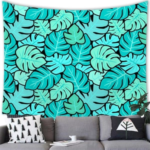 Tapisserie de feuilles de monstera tropicales en sarcelle et menthe au-dessus d'un canapé