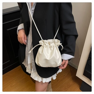Off-white cloud bucket bag with drawstring closure worn by model as a crossbody style