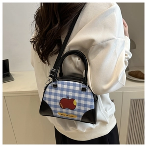 Gingham mini crossbody bowling bag with apple print shown on model for size perspective