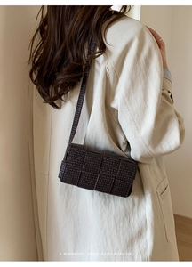 Detail of dark brown woven texture on a minimalist small square crossbody bag for women