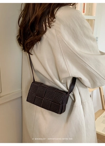 Detailed view of dark brown woven crossbody bag with sophisticated retro minimalist style
