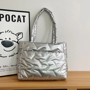 Silver quilted puffer tote bag with metallic finish and minimalist fashion label