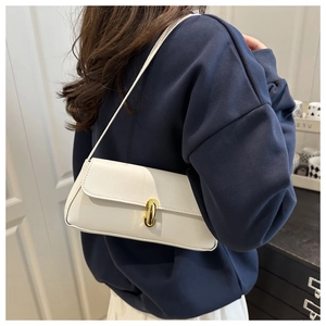 Detail of white grained leather shoulder bag with elegant gold-tone oval metal lock