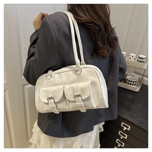Detailed view of a white vintage Boston shoulder bag with dual buckle pocket accents