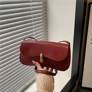 Deep red minimalist leather underarm bag with elegant gold metal buckle closure